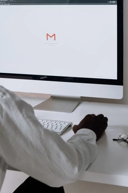 Three businesswomen collaborate with graphs and a laptop in a modern office setting.